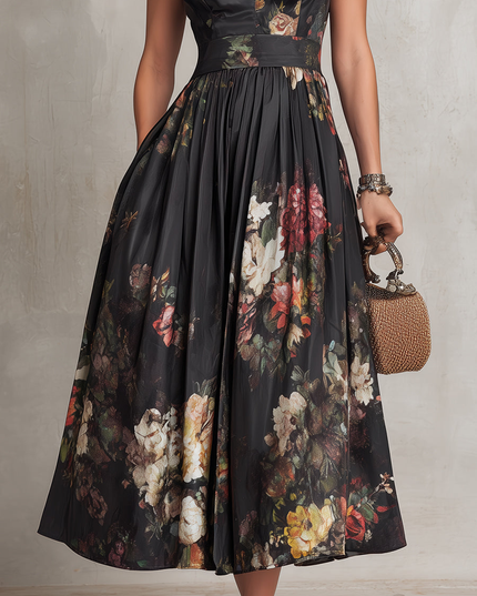Close-up of floral midi dress skirt with black sheer overlay and colorful flower print