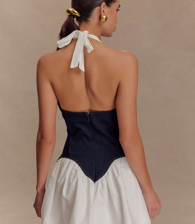 Back close-up of dark denim corset bodice and halter tie on women’s mini dress