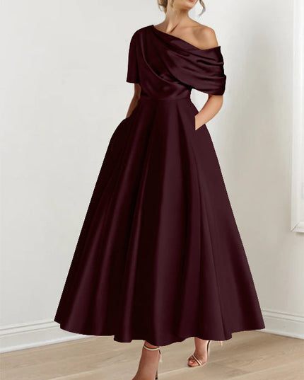 Deep plum one-shoulder maxi dress with draped neckline and flowing skirt