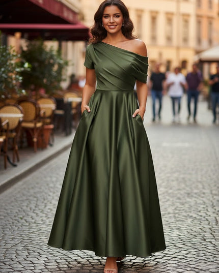 Olive green off-shoulder maxi dress styled for outdoor urban setting