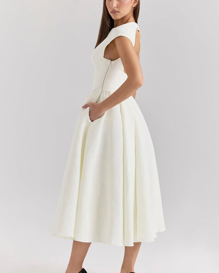 Side view of ivory cocktail dress with open back and fitted waist