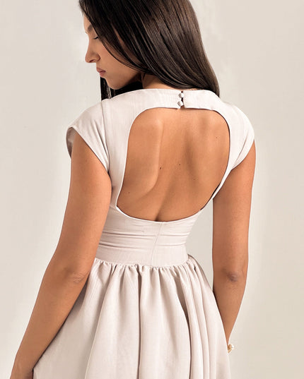 Close-up front view of ivory cocktail dress with boat neckline and fitted bodice