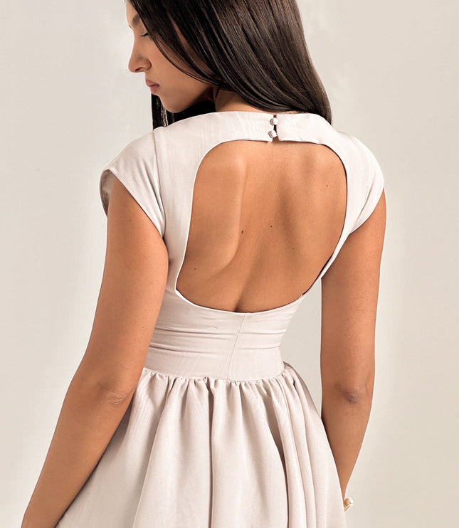 Close-up front view of ivory cocktail dress with boat neckline and fitted bodice