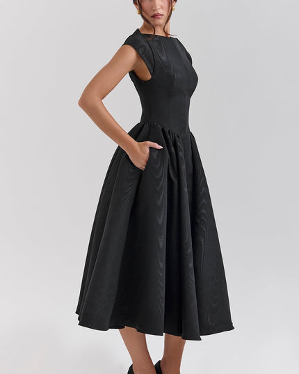 Side view of black open back midi dress with fitted waist and flared skirt