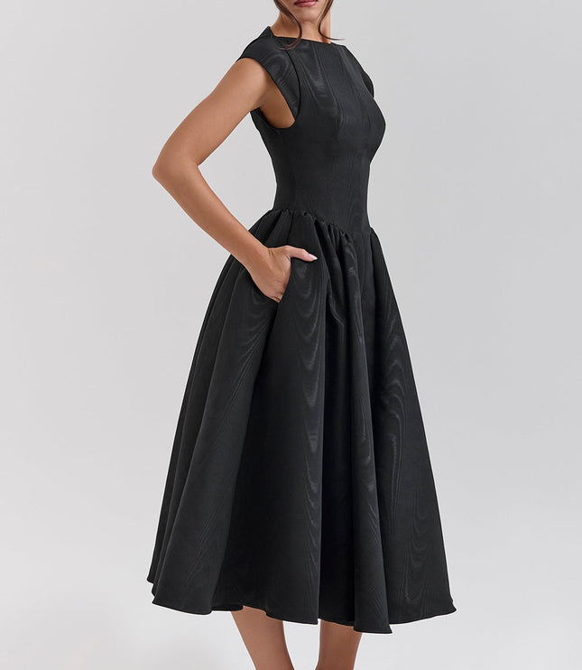 Side view of black open back midi dress with fitted waist and flared skirt