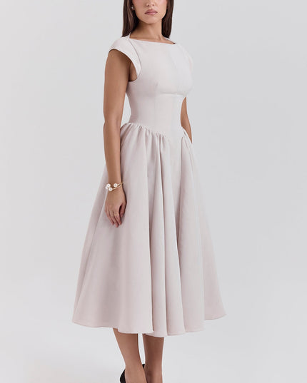 Front angled view of blush cocktail midi dress with open back and cap sleeves