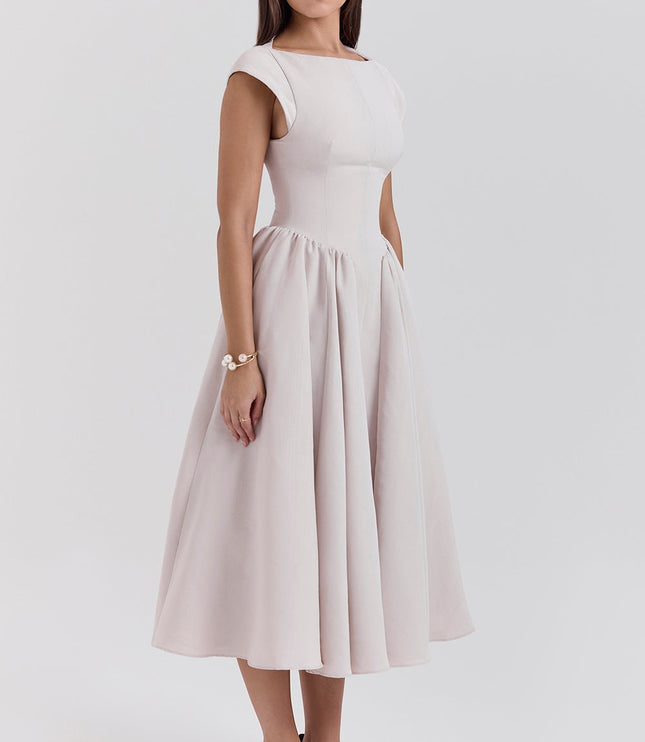 Front angled view of blush cocktail midi dress with open back and cap sleeves