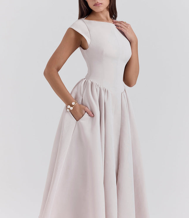 Side view of a blush cocktail midi dress with cap sleeves and gathered skirt
