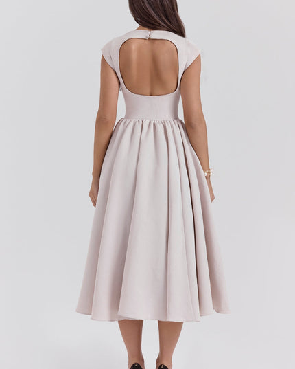 Back view of a blush open back midi dress with cap sleeves and flared skirt