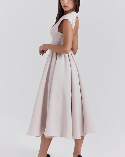 Three-quarter back view of a blush open back cocktail dress with a full midi skirt