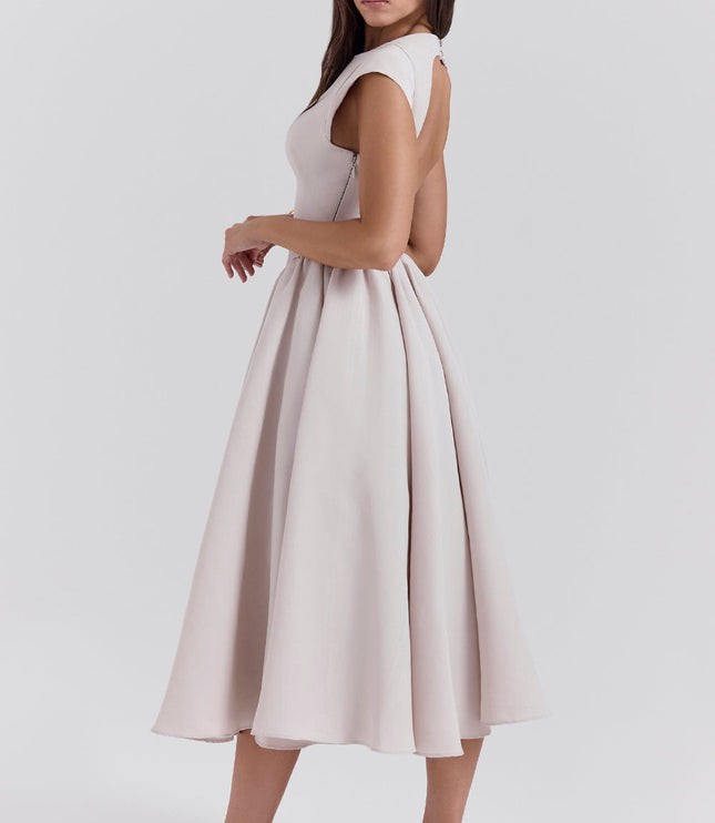 Three-quarter back view of a blush open back cocktail dress with a full midi skirt