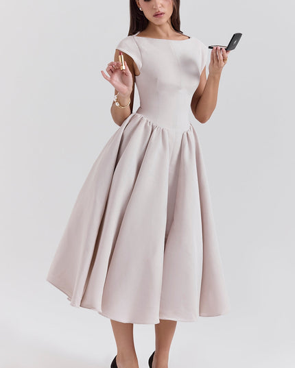 Front view of a blush midi cocktail dress with cap sleeves and voluminous skirt
