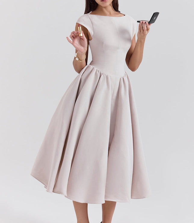 Front view of a blush midi cocktail dress with cap sleeves and voluminous skirt