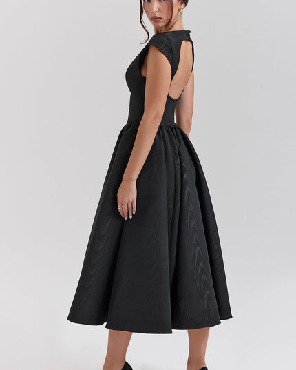 Rear side view of black cocktail midi dress showing open back and cap sleeves