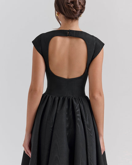 Back view of black cocktail dress with large open back and fitted bodice