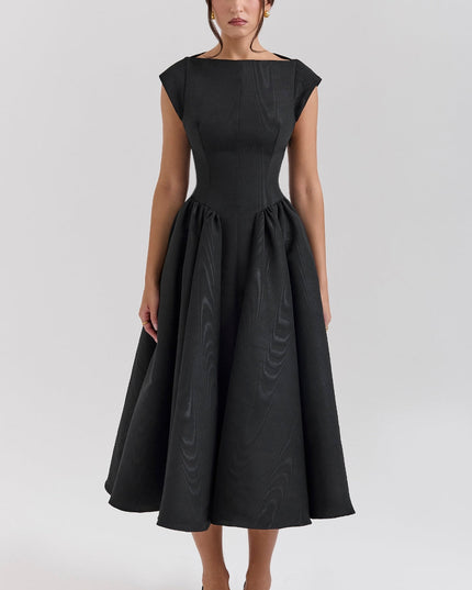 Black midi cocktail dress with open back, cap sleeves, and full flared skirt