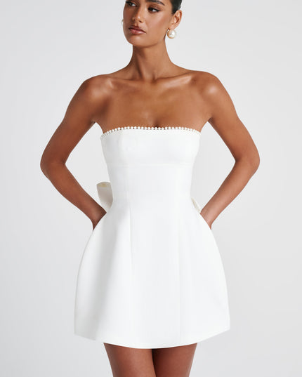 Front view of white strapless dress with pearl beading and structured fit