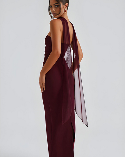 Back view of burgundy strapless maxi dress with sheer overlay and open back detail