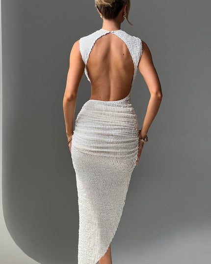 Back view of white textured one piece swimsuit style dress with open back cutout