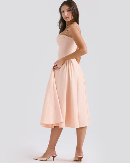 Side view of blush midi dress with adjustable straps, fitted waist, and flared skirt