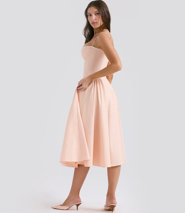 Side view of blush midi dress with adjustable straps, fitted waist, and flared skirt