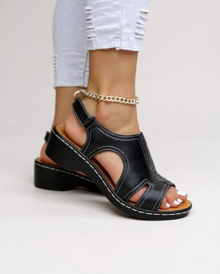 Black leather comfort wedge sandals with cutout design and adjustable ankle strap