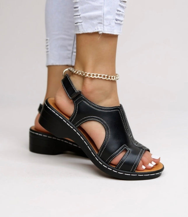 Black leather comfort wedge sandals with cutout design and adjustable ankle strap
