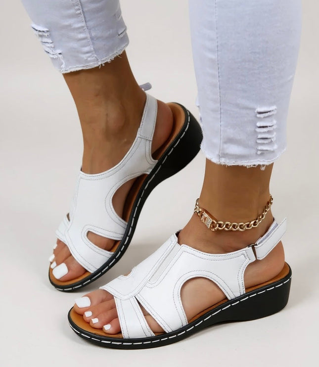 White leather peep toe wedge sandals with adjustable strap and black platform sole