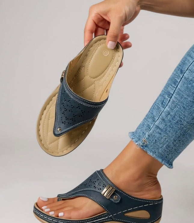 Black thong sandal sole view showing quilted cushioned footbed and arch support