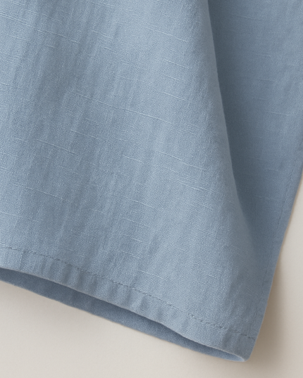 Close-up of light blue cotton fabric texture and weave detail
