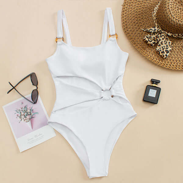 White cut out one piece swimsuit laid flat with square neckline and ring detail