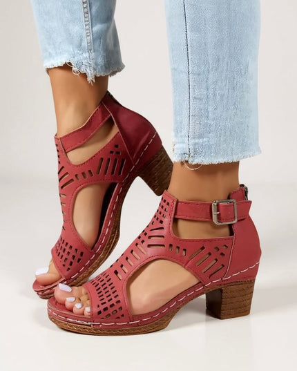 Red cutout block heel sandals with buckle ankle strap and geometric perforations