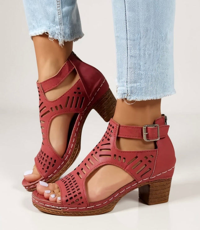 Red cutout block heel sandals with buckle ankle strap and geometric perforations