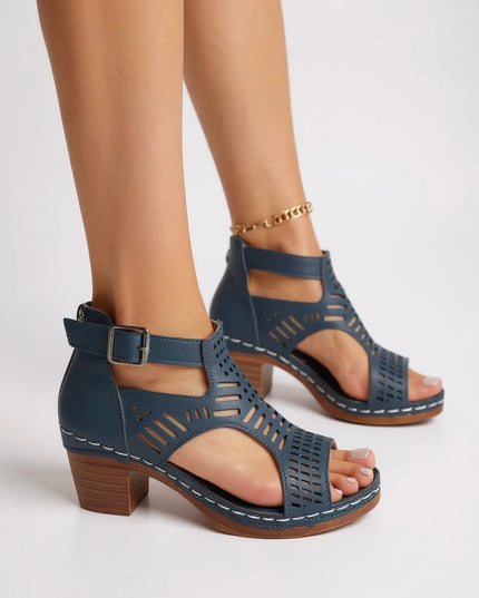 Dark blue cutout block heel sandals with buckle ankle strap and geometric perforations