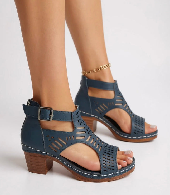 Dark blue cutout block heel sandals with buckle ankle strap and geometric perforations