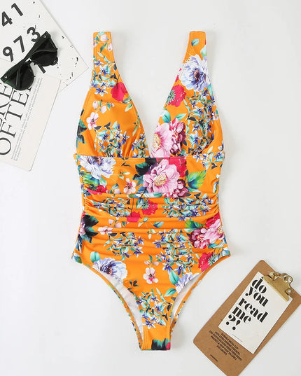 Orange floral v-neck one piece swimsuit with pink and white blooms, flat lay