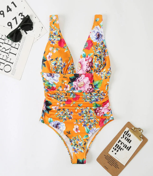 Orange floral v-neck one piece swimsuit with pink and white blooms, flat lay