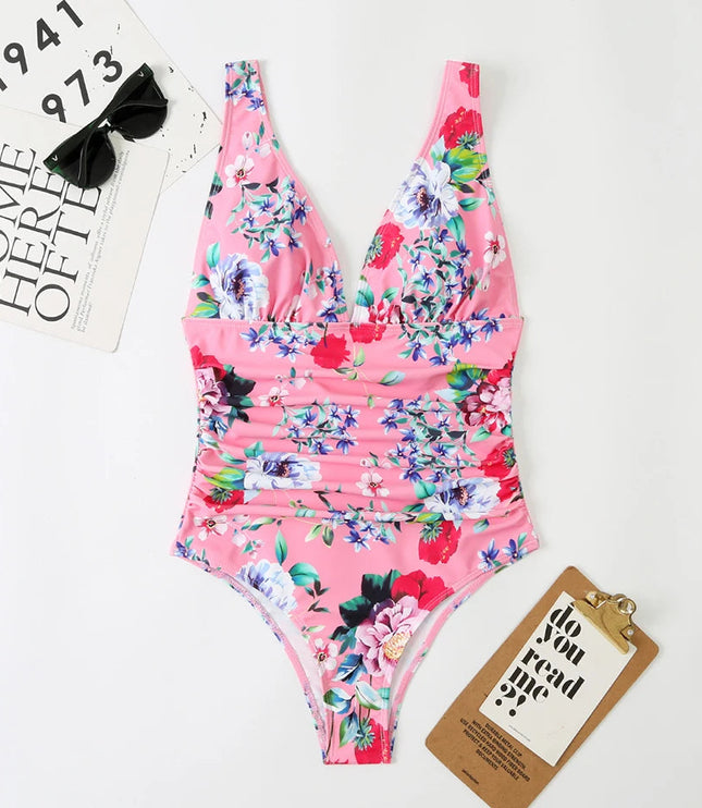 Pink floral v-neck one piece bathing suit with ruched details, overhead view