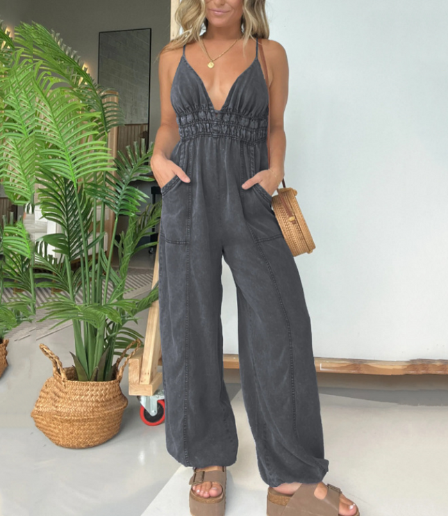 Charcoal gray denim v-neck jumpsuit with spaghetti straps and relaxed wide-leg fit