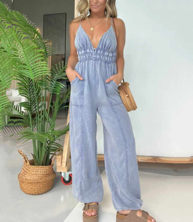 Light blue denim v-neck spaghetti strap jumpsuit with wide legs and pockets
