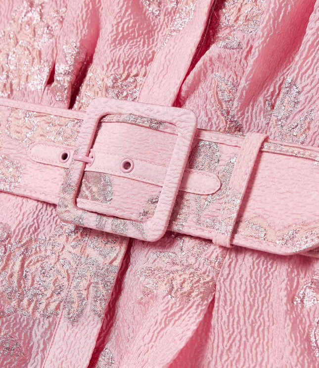 Close-up of pink belted maxi dress showing textured floral fabric and buckle detail