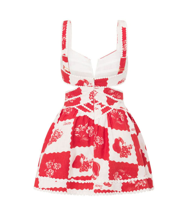 Flat lay back of red floral mini dress showing pearl-trimmed cutout pattern