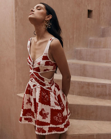Red and white floral mini dress with pearl trim cutouts and sleeveless design