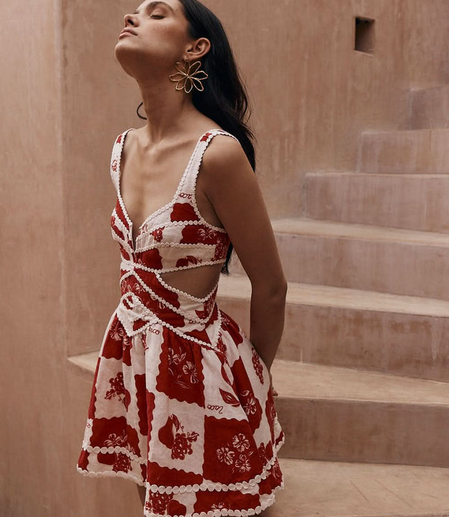 Red and white floral mini dress with pearl trim cutouts and sleeveless design