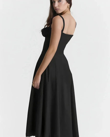 Back view of black spaghetti strap midi dress with fitted waist and flowing skirt