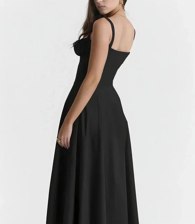 Back view of black spaghetti strap midi dress with fitted waist and flowing skirt