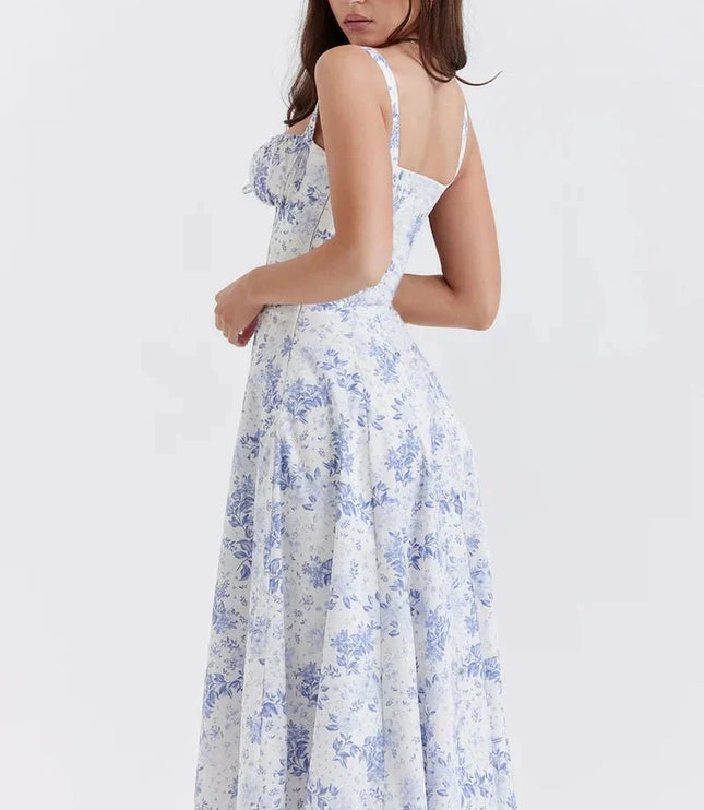 Side view of blue floral midi dress showing fitted waist, straps, and flowing skirt