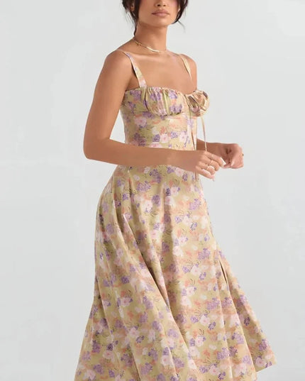 Front view of yellow floral midi dress with ruched bust, fitted waist, and flared skirt