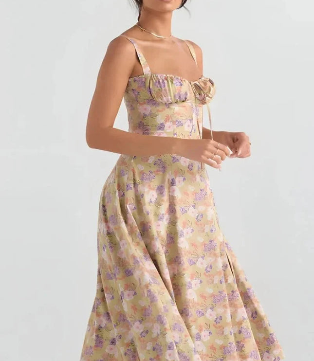 Front view of yellow floral midi dress with ruched bust, fitted waist, and flared skirt