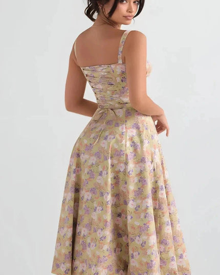 Back view of yellow floral midi dress with open back, straps, and gathered waist
